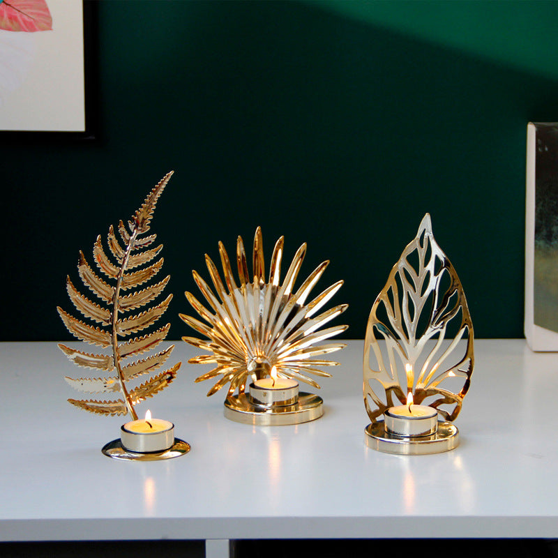 Gold leaf metal tea light candle holders in fern, palm and filigree leaf designs