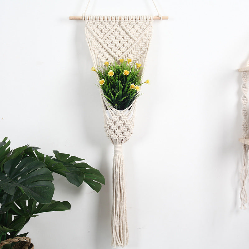 Cream Macramé Wall Hanging Planter styled with a small green potted plant against a white wall