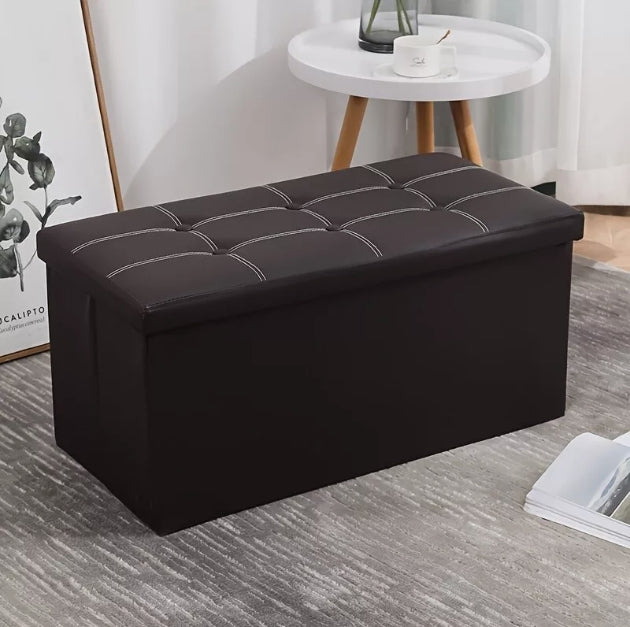 Black folding storage ottoman bench in a living room