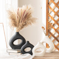 Black and white hollow ceramic vases styled with pampas grass
