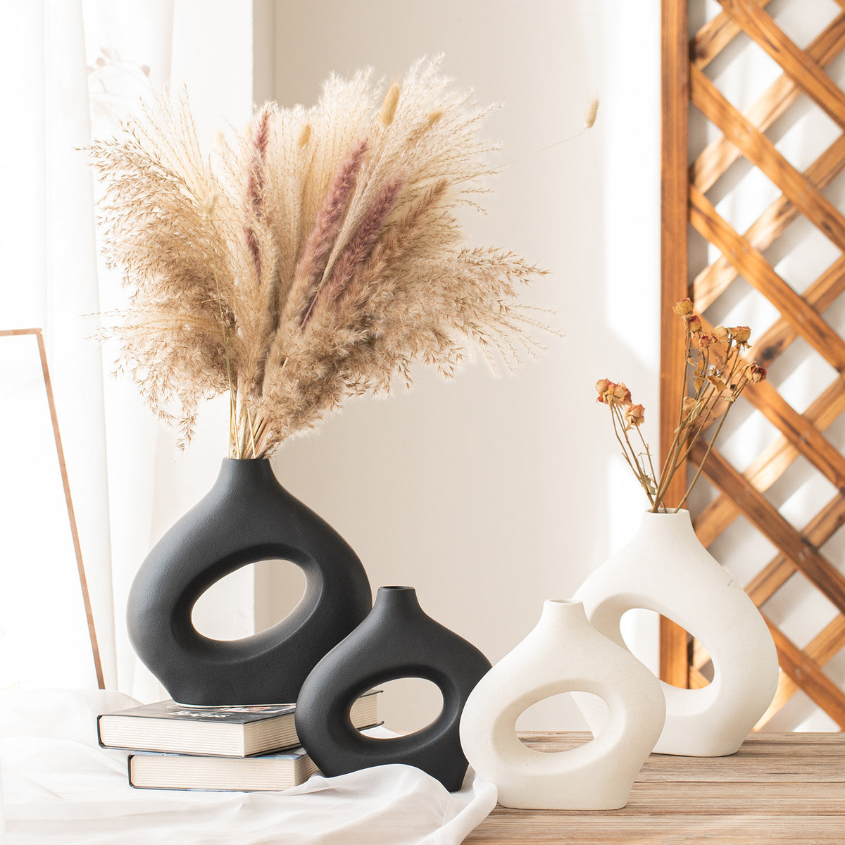Black and white hollow ceramic vases styled with pampas grass