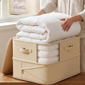 Beige collapsible duvet storage bag holding a folded duvet