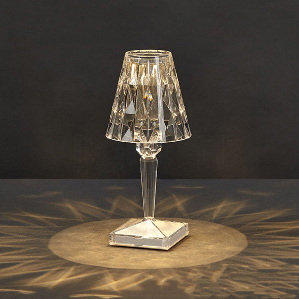 Cordless faceted crystal table lamp glowing on a table