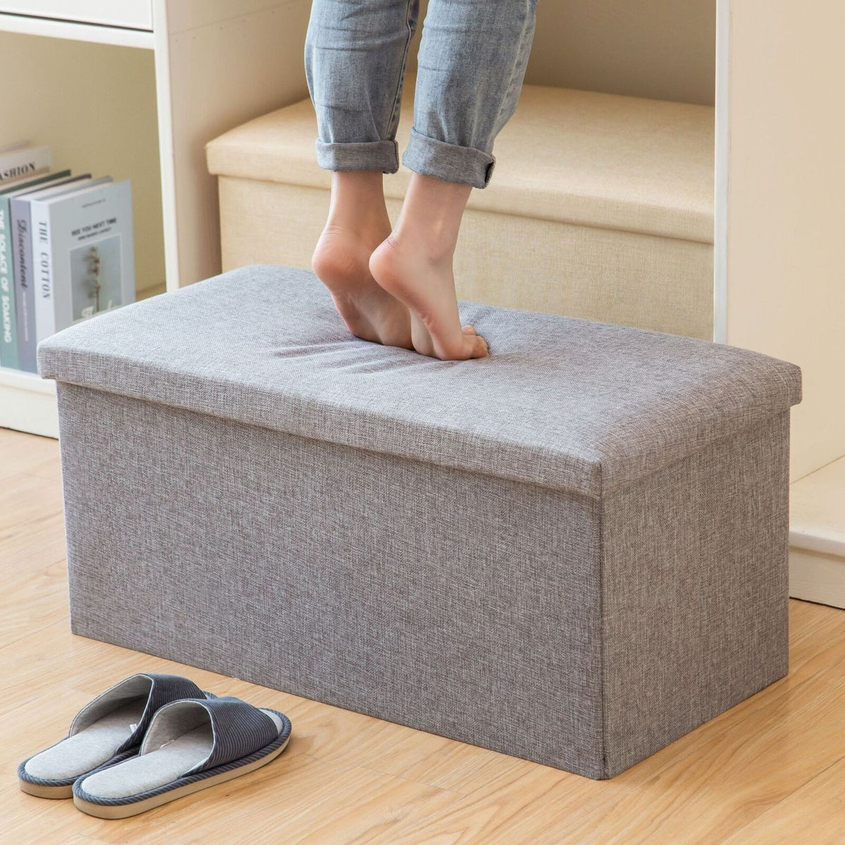 Grey ottoman used as a footrest
