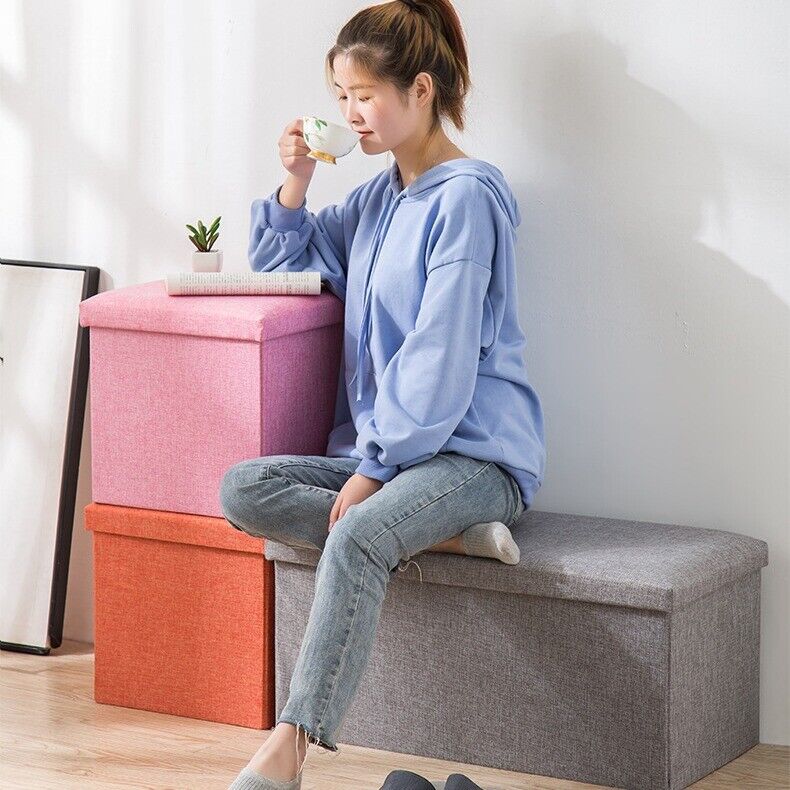 Grey ottoman footstool used as a seat
