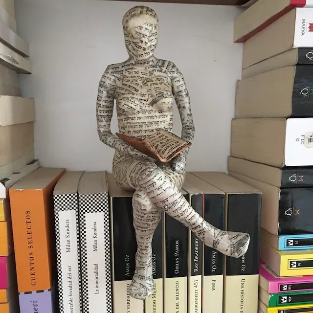 Reading woman resin statue in gravity