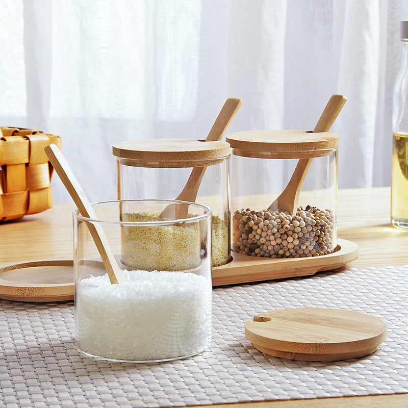 Bamboo Lid Glass Storage Jars filled with sea salt and spices on a kitchen table